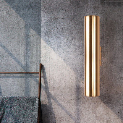 Vägglampa i cylinderform med guldfinish