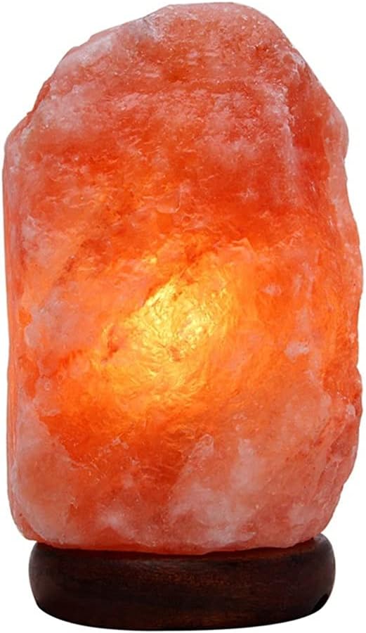 Massiv saltlampa i rå stenform med träfot